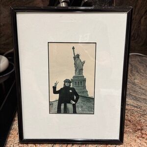 John Lennon giving the peace sign at Statue of Liberty New York. Beatles.